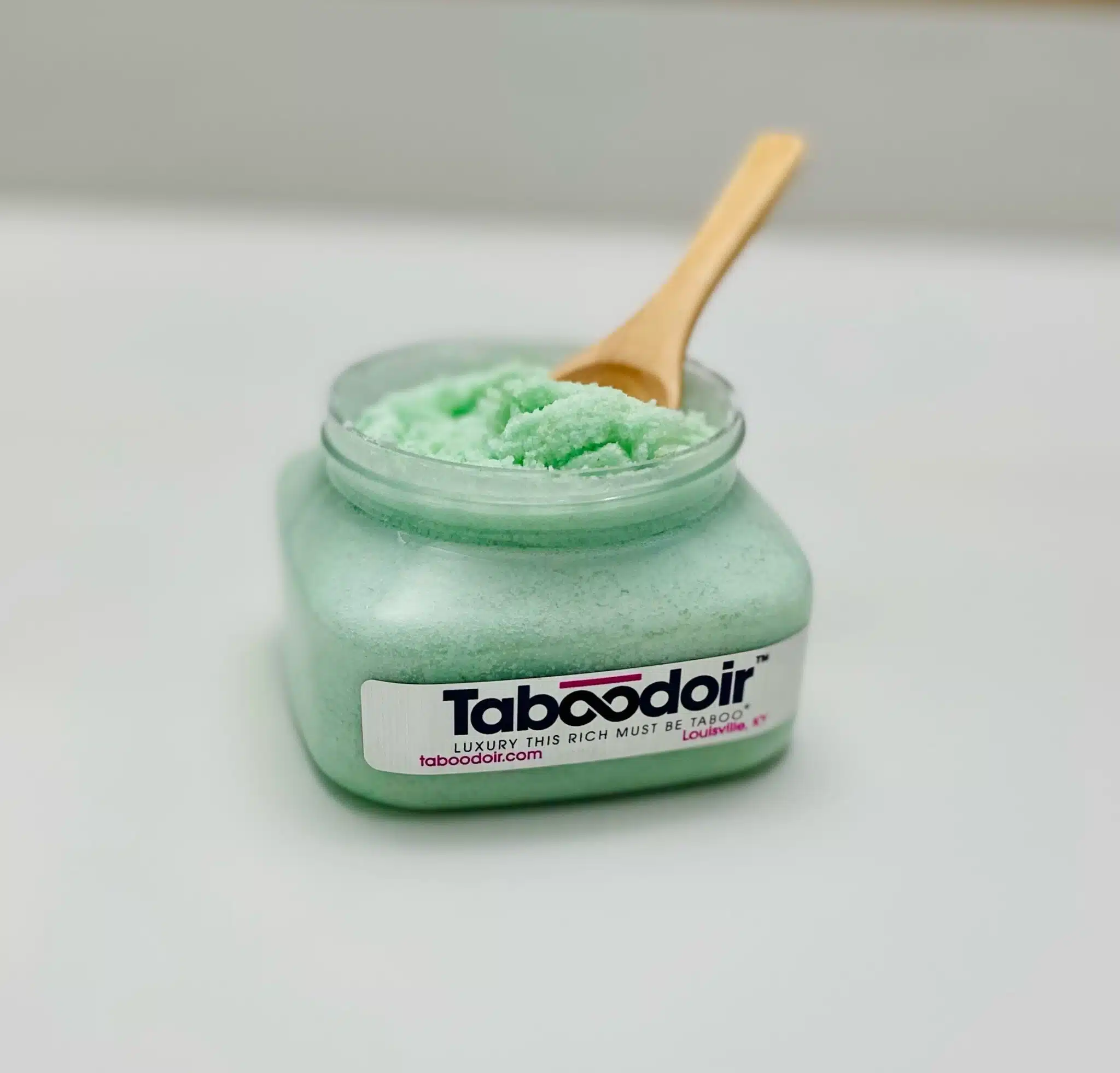 open jar of scrub with spoon in jar