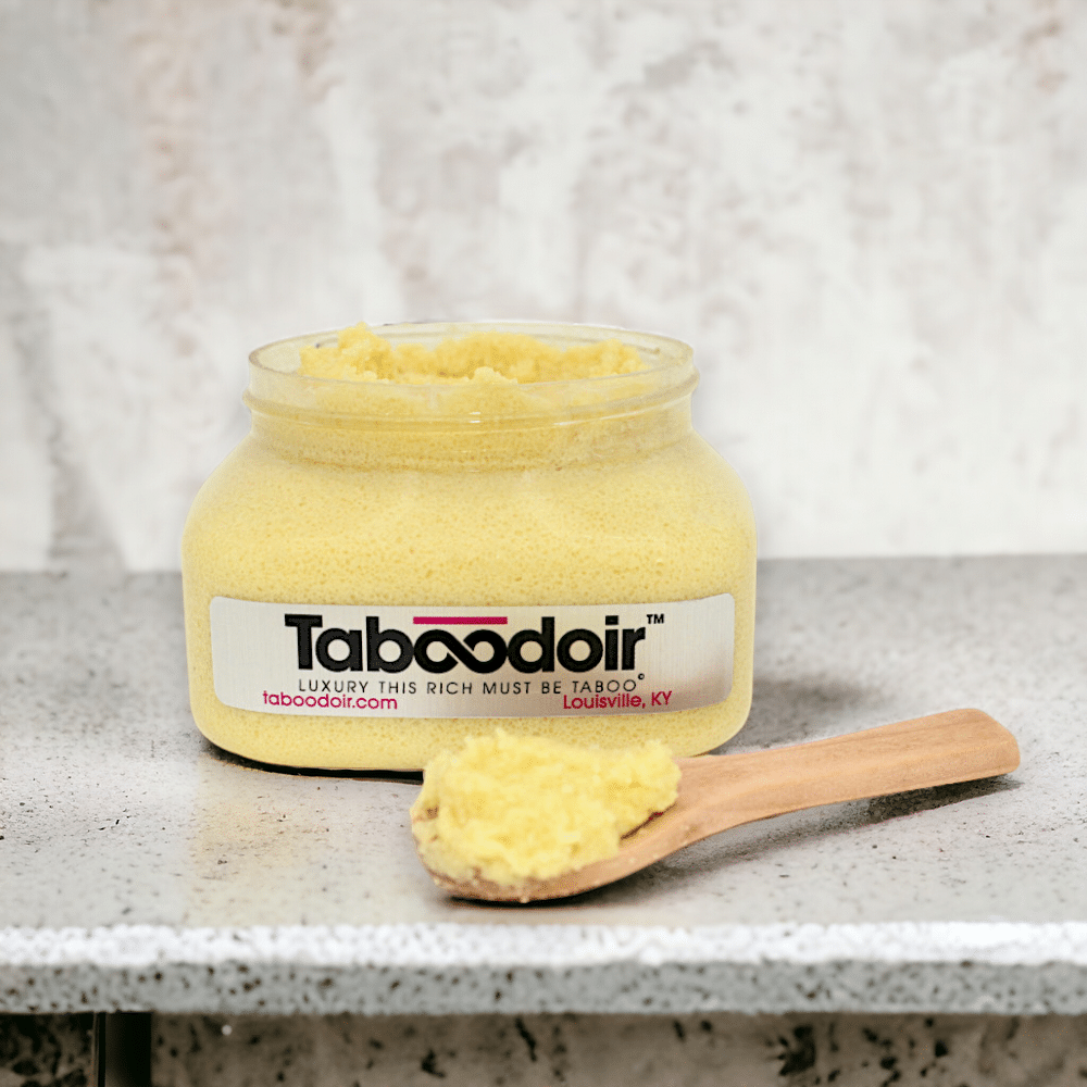 open jar of Taboodoir Citrus Bliss Body Polish with a wooden spoon