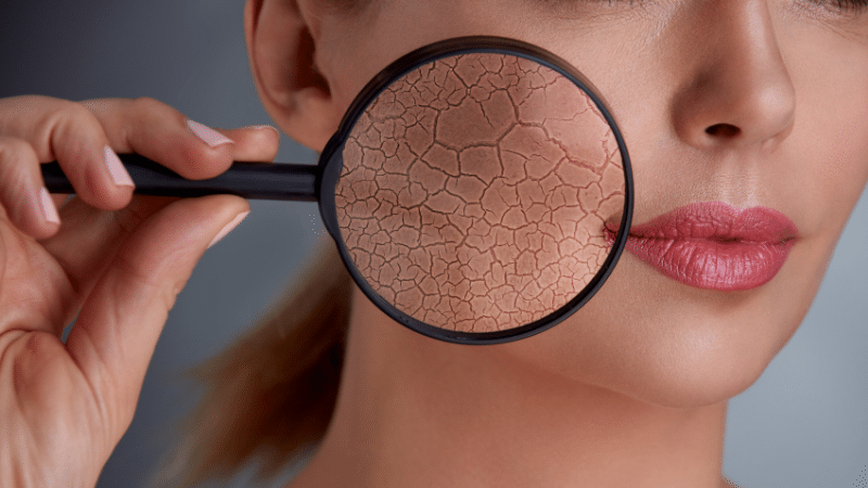 woman holding magnifier to face to show damage