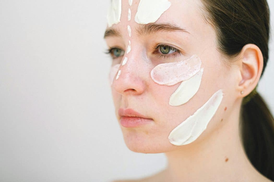 woman with excess skincare on her face