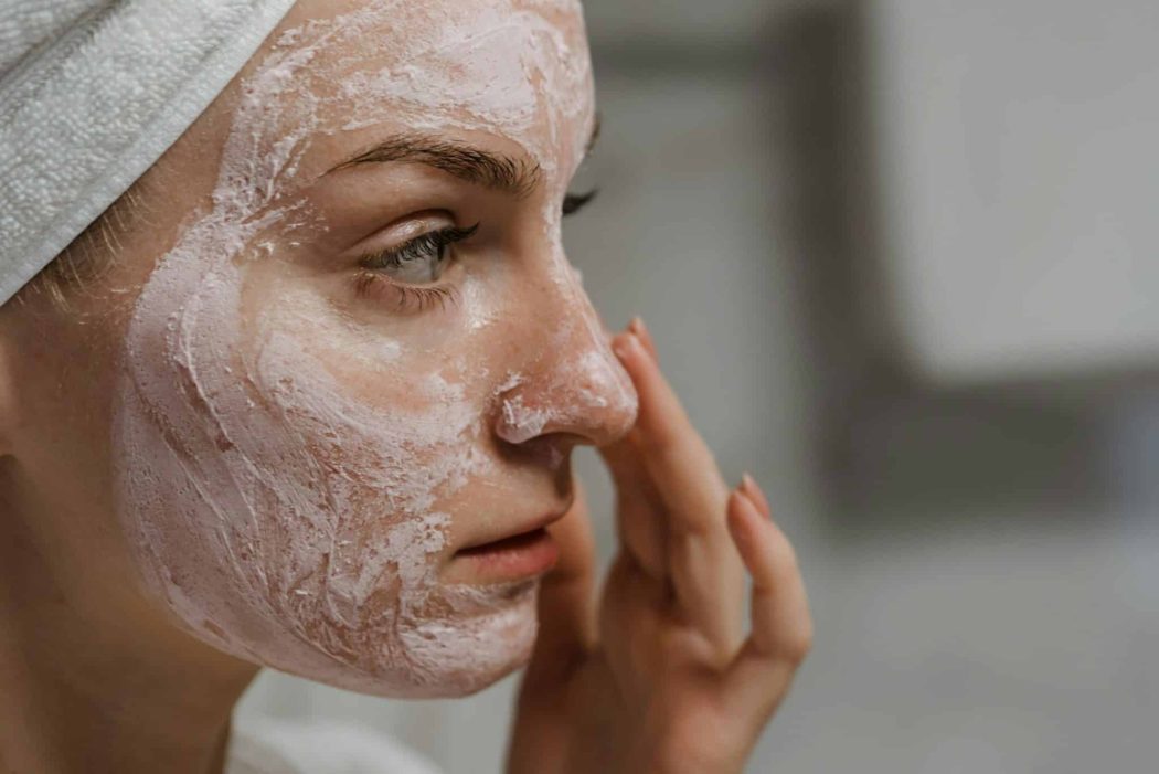 woman applying mask