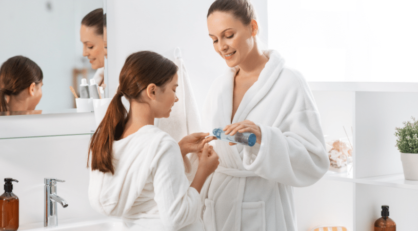 Mom and daughter in robes applying skincare