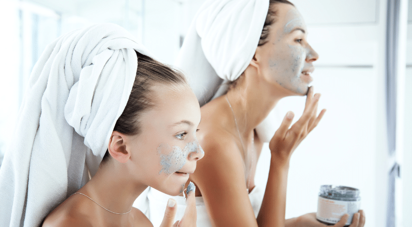 Mom and daughter applying facial scrub