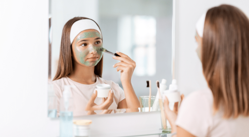 Young girl applying mask