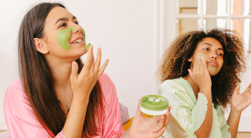 Young girls applying masks