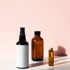 Three Brown Bottles on a Pink Background